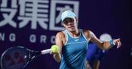 Magda Linette hits a forehand